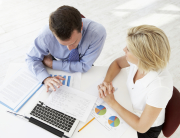 Overhead View Of Businesswoman And Businessman Working At Desk Together