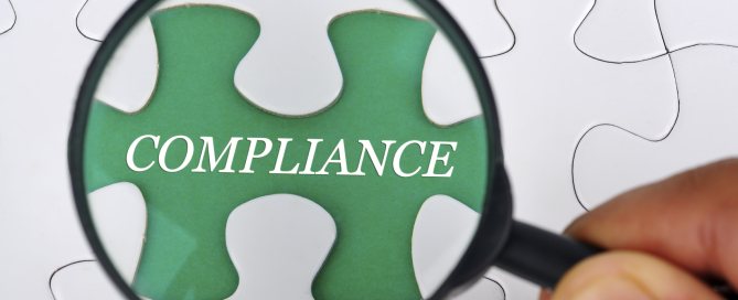 Hand Holding Magnifying Glass Seaching Missing Puzzle Pieces "COMPLIANCE"